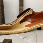 Cross-sectioned leather shoe showing layered sole construction and welt